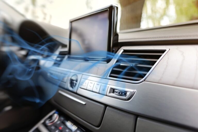 Cool air flowing from a vehicle dashboard vent, showing auto air conditioning ready for summer driving.