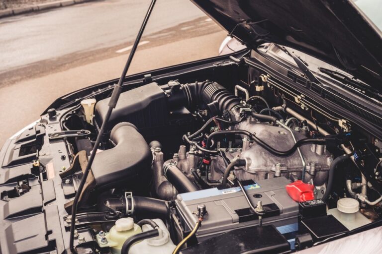 Car engine with the hood open, related to engine noises that require immediate attention and auto repair inspection.